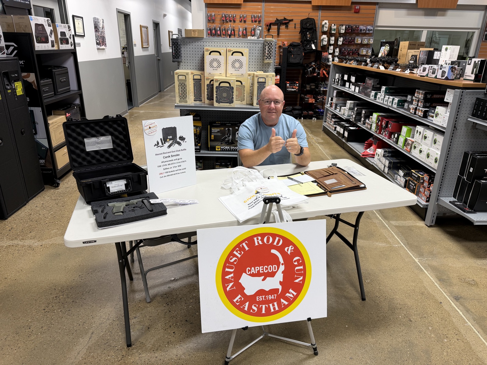 Nauset Rod & Gun Club table at Cape Gun Works with the club sign and the Canik Smoke raffle display